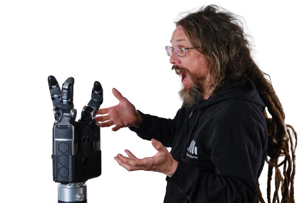 rich walker looking surprised and excited with the new shadow robot hand